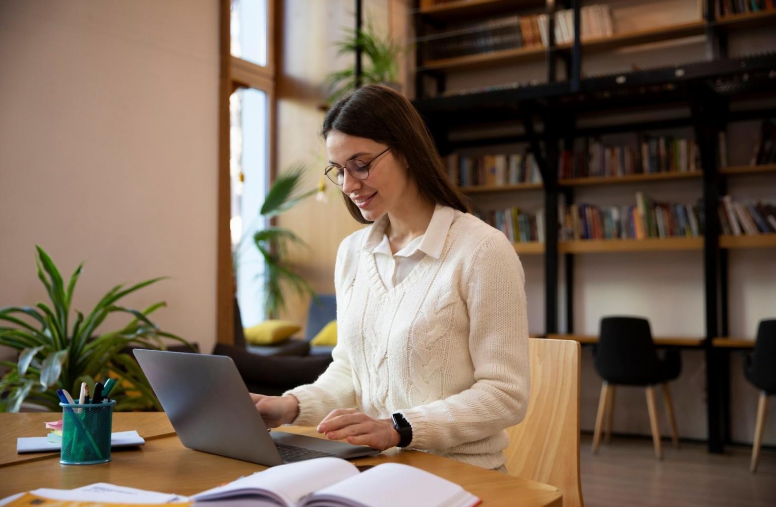 Professional analyzing budget categories on laptop